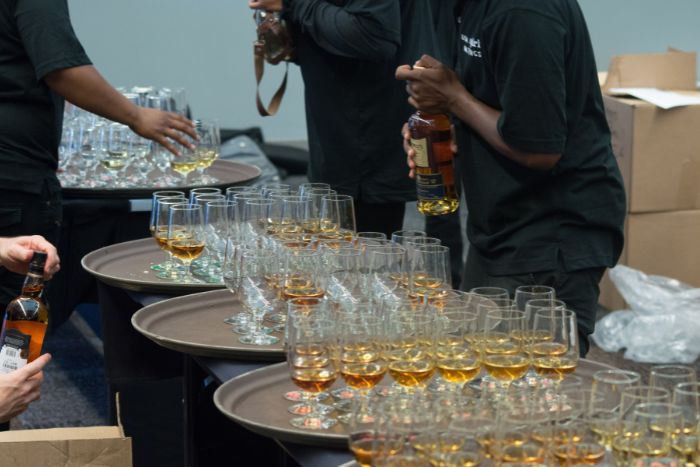 A flight of Whiskey being poured