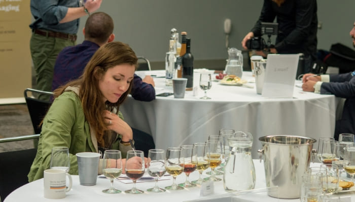 Spirits Judge examining and tasting various spirits drinks at 2018 USA Spirits Ratings